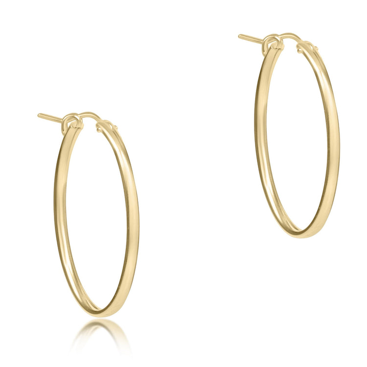 Pair of smooth 1-inch oval 14kt gold-filled hoop earrings against a white background.