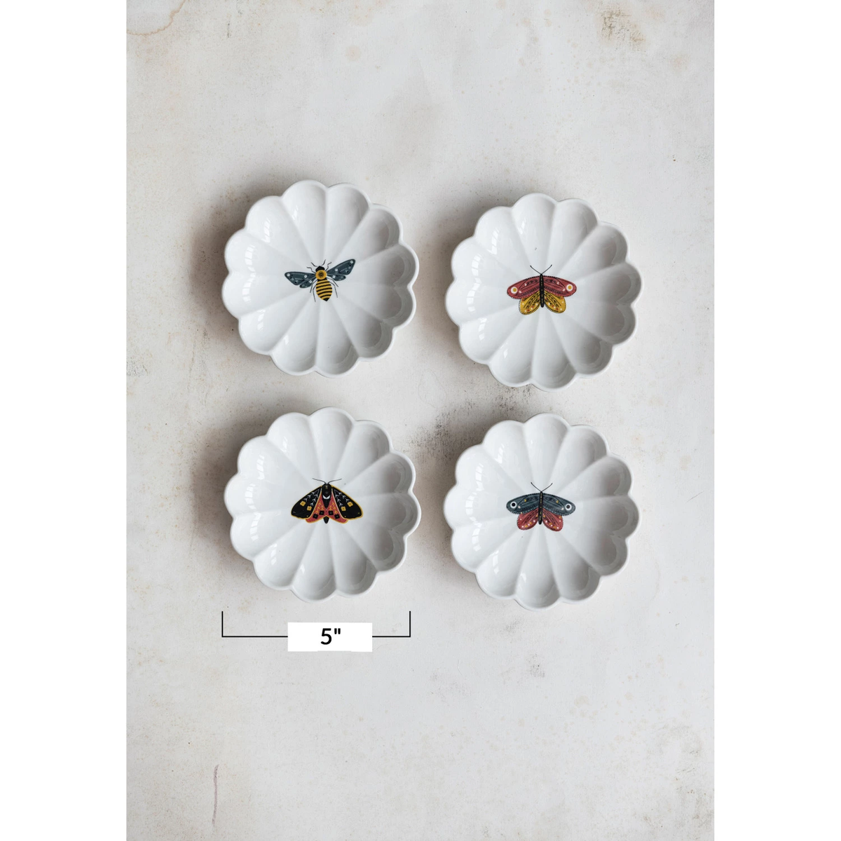 Round stoneware scalloped dish in natural color with an insect silhouette.