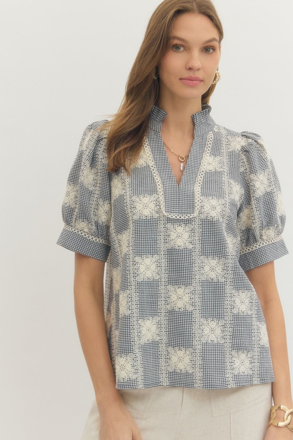 Amanda Gingham Puff Sleeve Top in white with black gingham pattern featuring unlined woven fabric and puff sleeves.