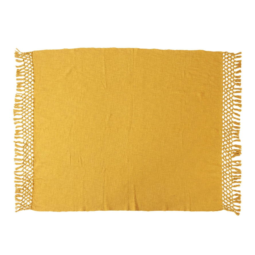 Woven cotton throw blanket in natural beige with crochet trim and fringe edges.