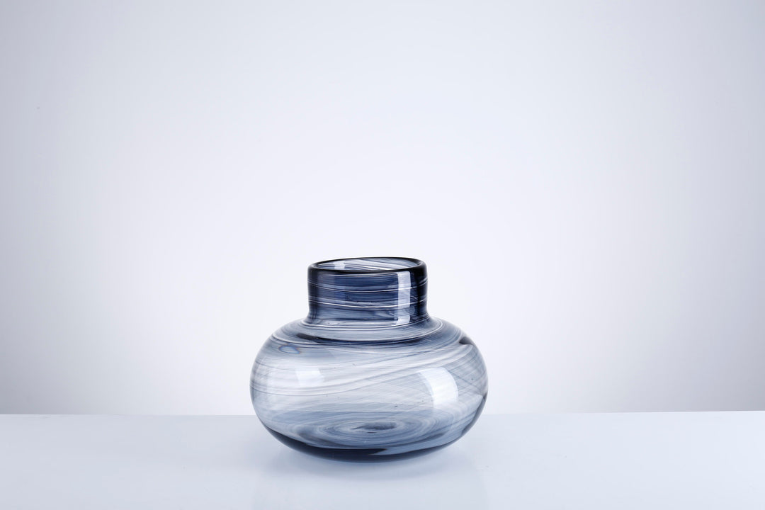 Glass vase with a square silhouette featuring subtle vertical texture.