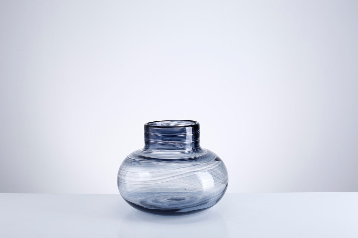 Glass vase with a square silhouette featuring subtle vertical texture.