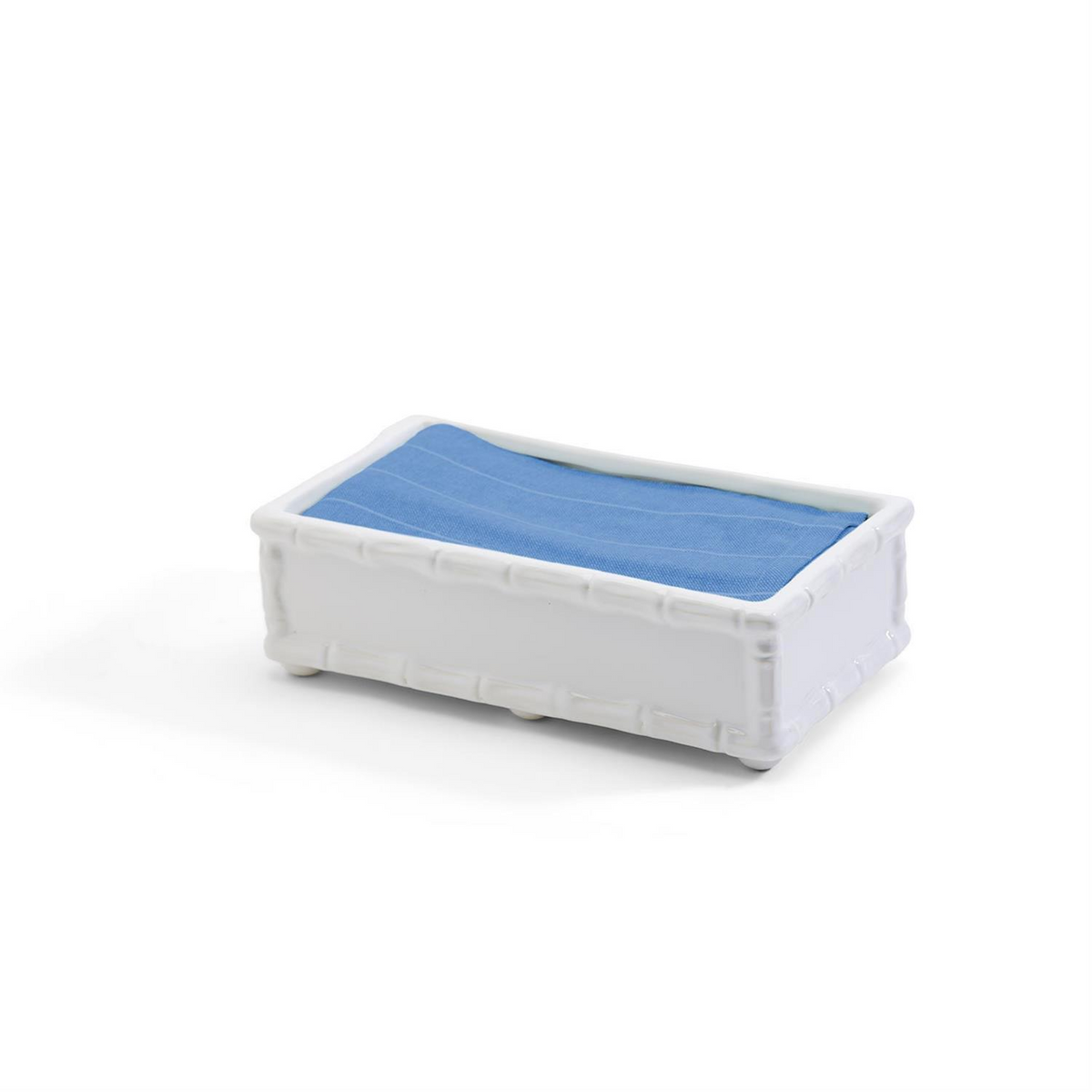 White ceramic faux bamboo guest towel holder with blue napkins inside.