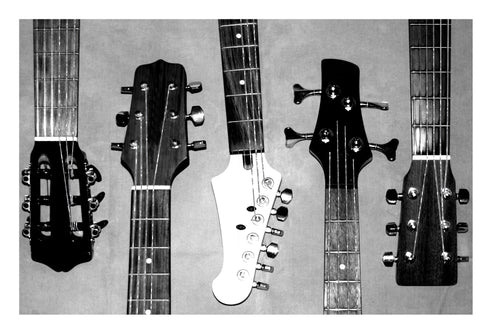 Five guitar necks and heads, including acoustic, electric, and bass guitars.