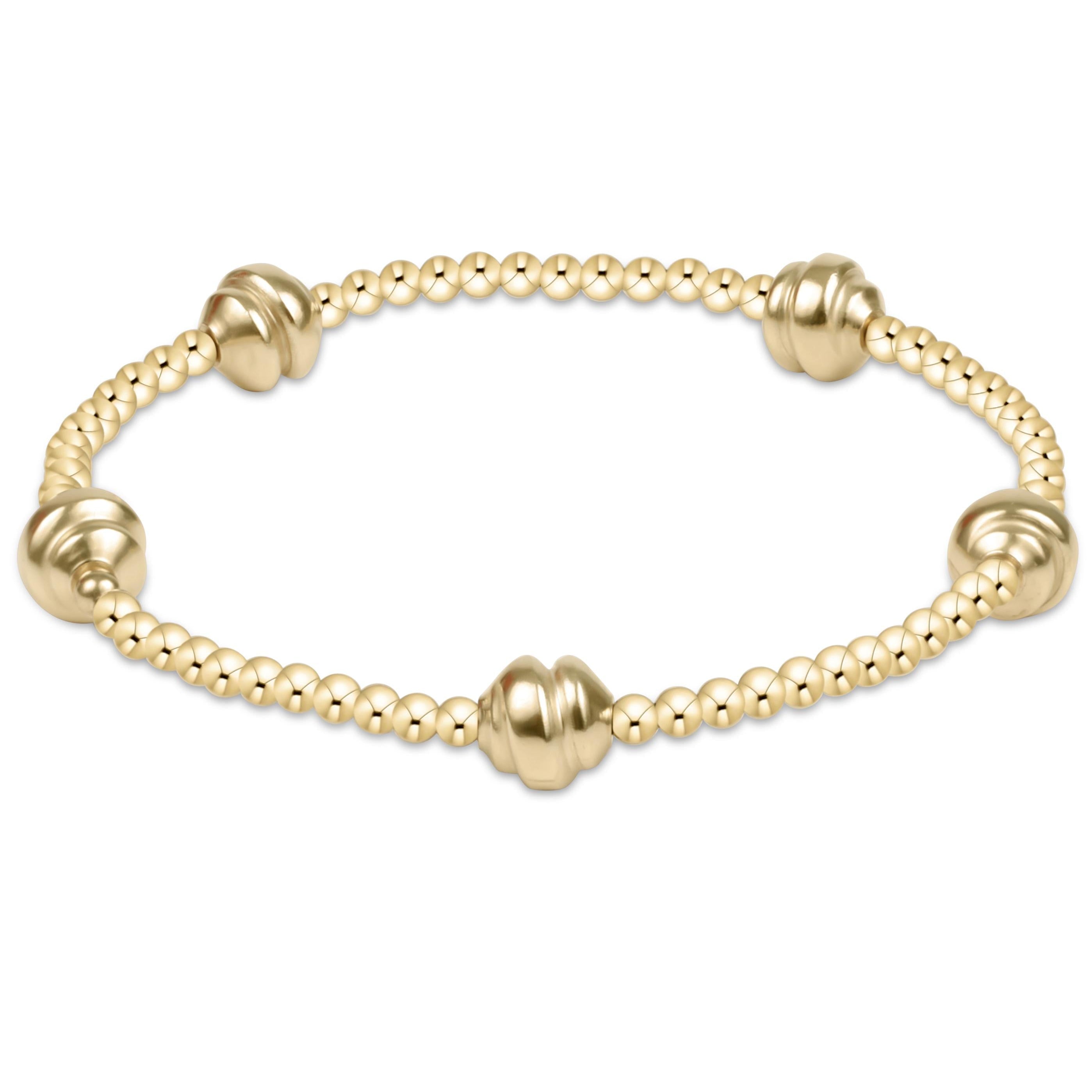 Small gold bracelet featuring hand-beaded 2.5mm gold-filled beads on stretch elastic.