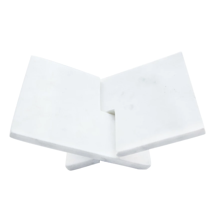 Interlocking marble book holder in white with a geometric cutout pattern.