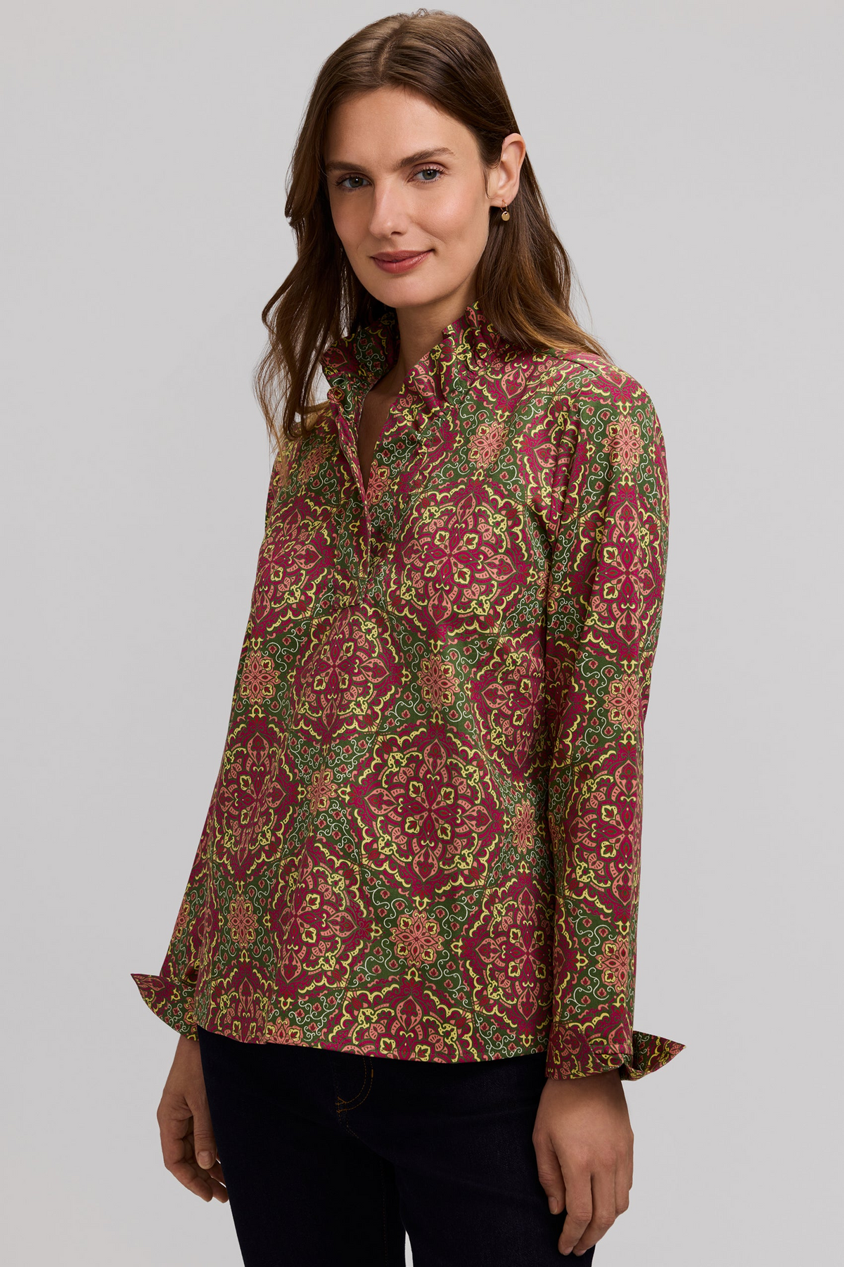 Woman wearing a Tammy Fall Medallion long sleeve popover shirt with a ruffle neckline.