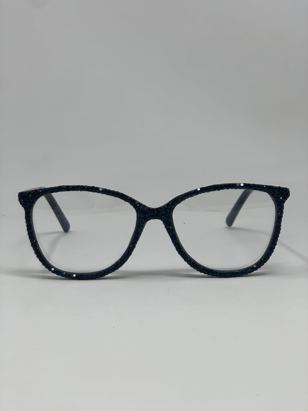 Black cat-eye reading glasses with shimmering rhinestone-encrusted frames.