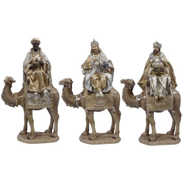Three resin nativity figures of kings riding camels, each holding a gift.