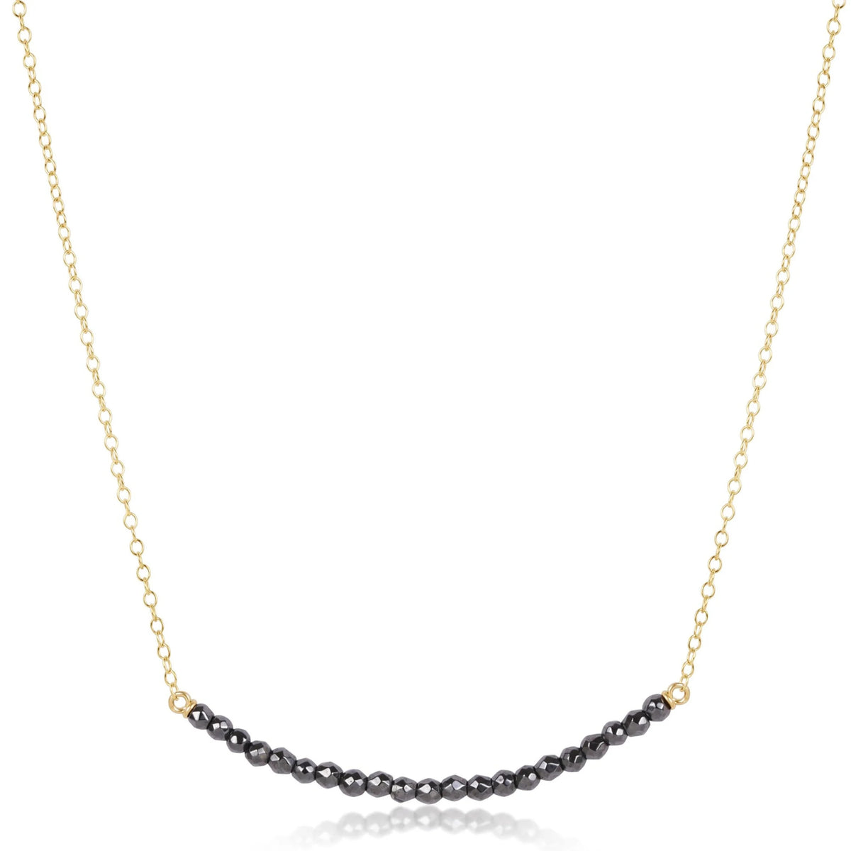 16-inch gold-filled chain necklace featuring a curved row of faceted black hematite beads.