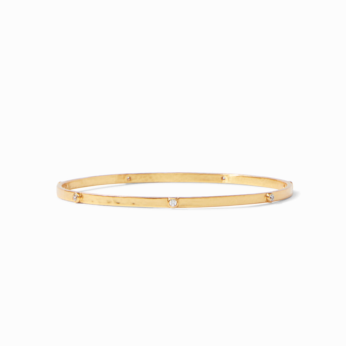 Lightly hammered gold bangle with gemstone stations.
