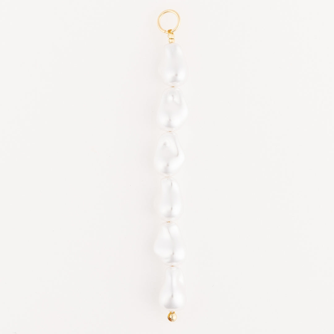 Tropical Bag Charm featuring a vertical row of six white baroque pearls with 18K gold-plated clasp.