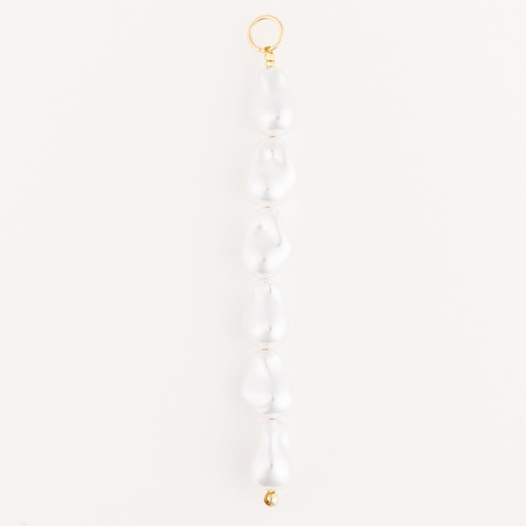 Tropical Bag Charm featuring a vertical row of six white baroque pearls with 18K gold-plated clasp.