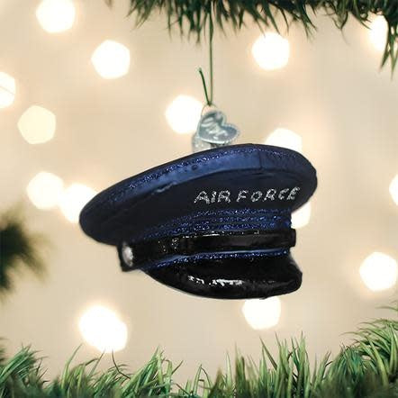 Blue Air Force cap ornament with gold emblem on black background