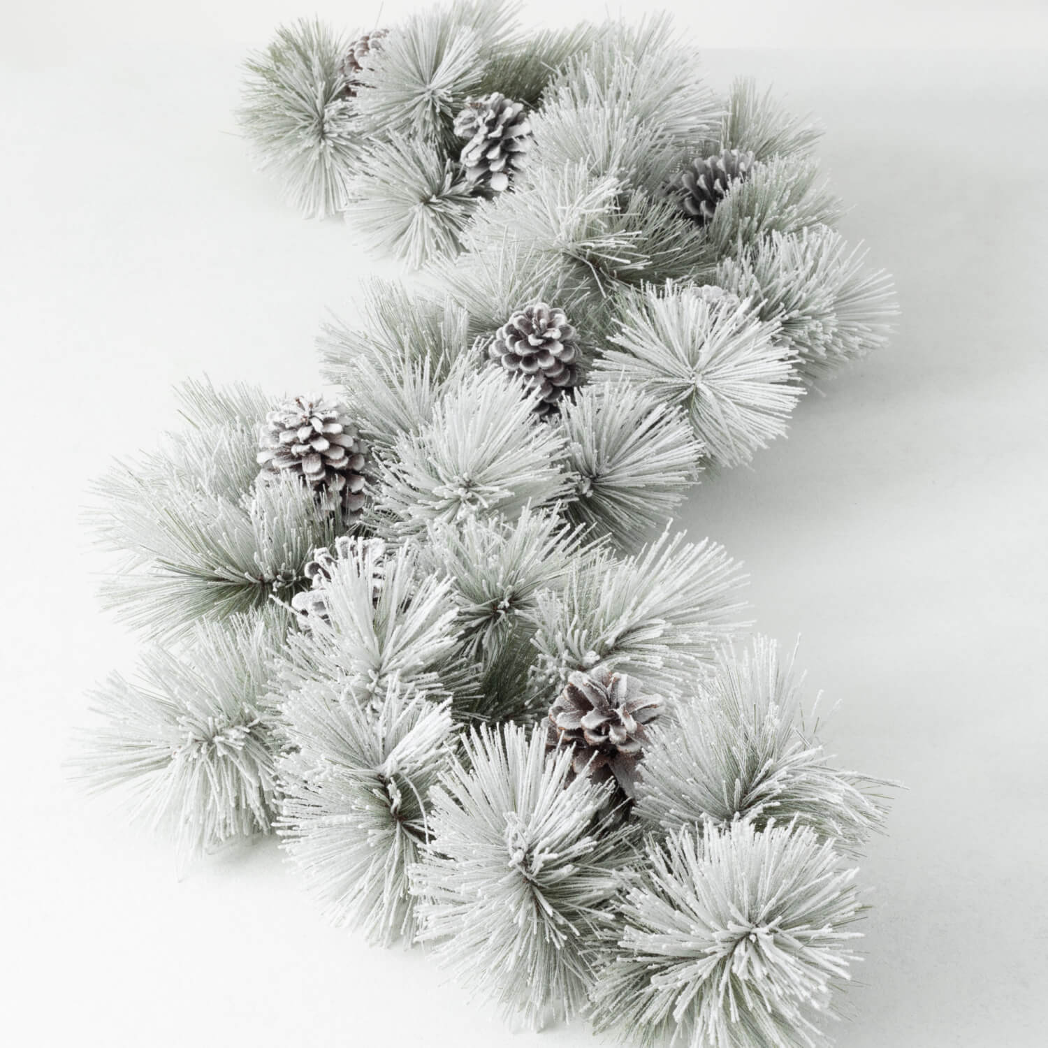 A 6-foot flocked green pine garland with frosted needles and decorative pinecones.