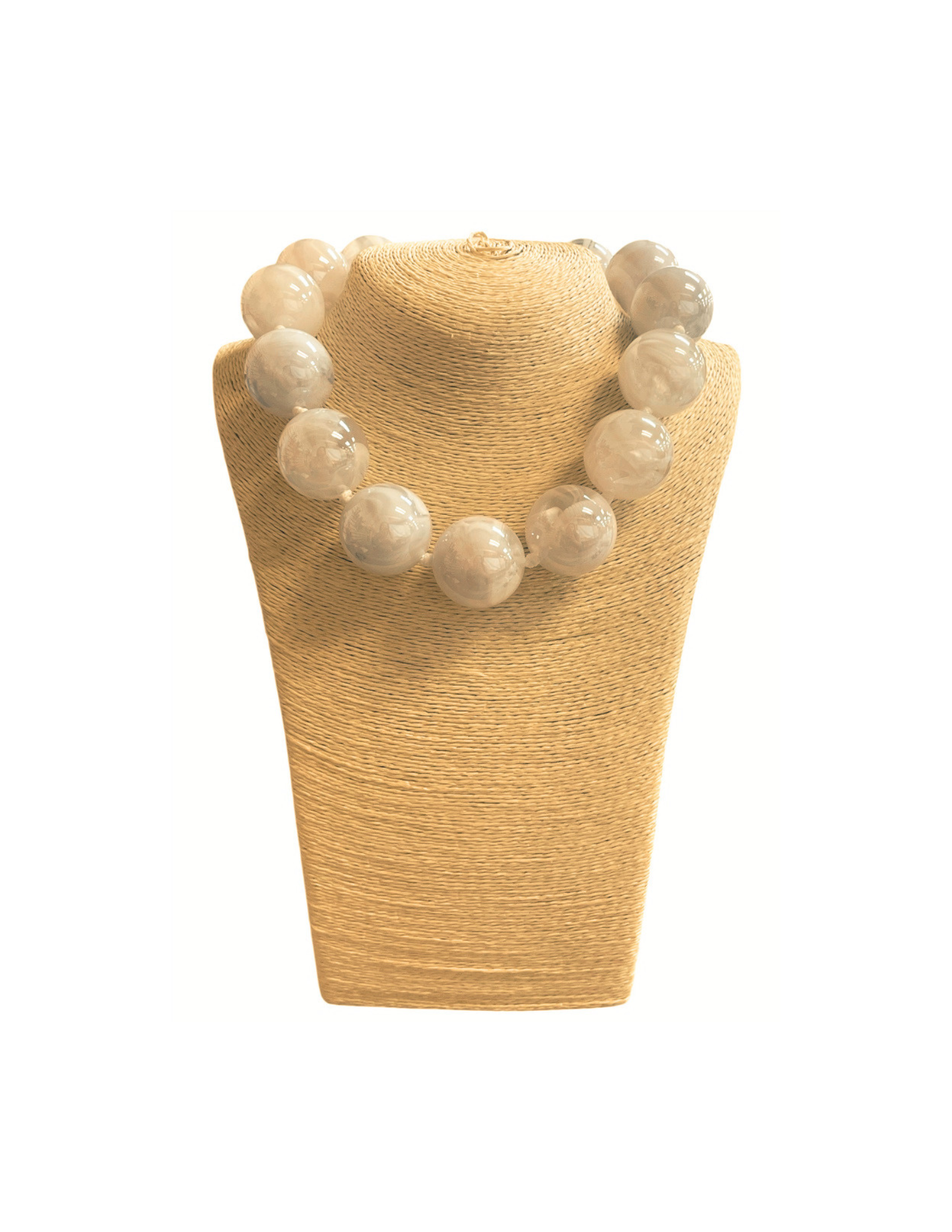 Short necklace featuring large, translucent white glass ball beads on a tan display bust.