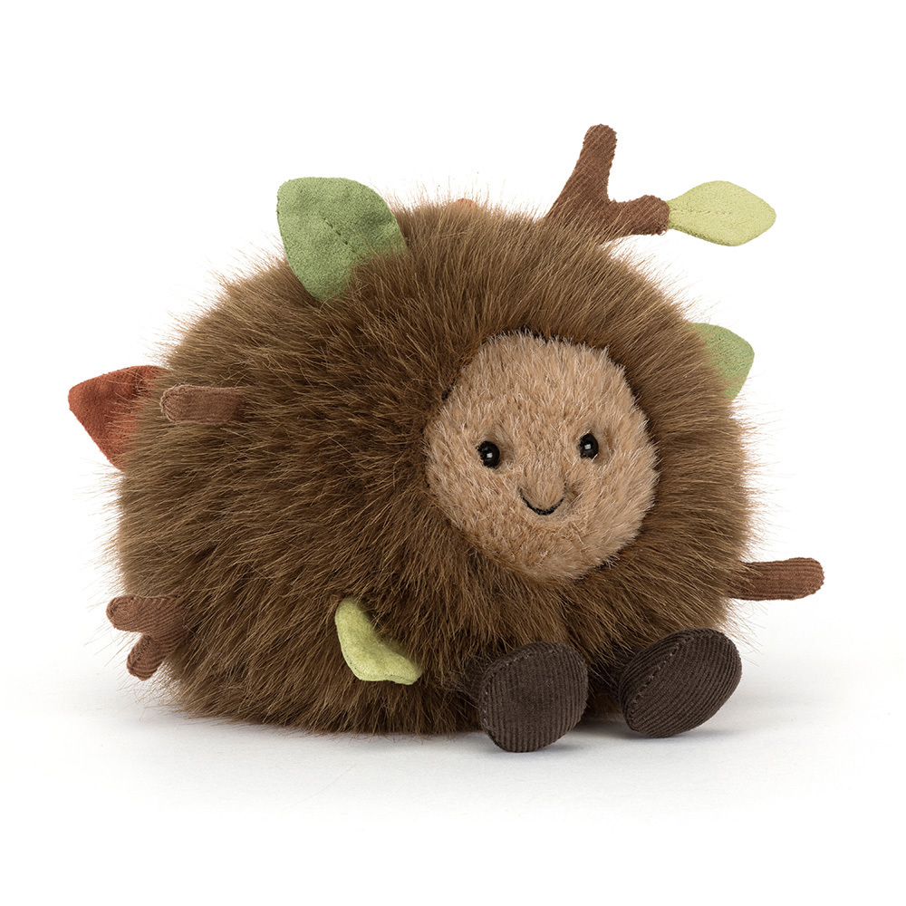 Round brown fuzzy plush toy with a smiling face, green leaves, and small brown branches.