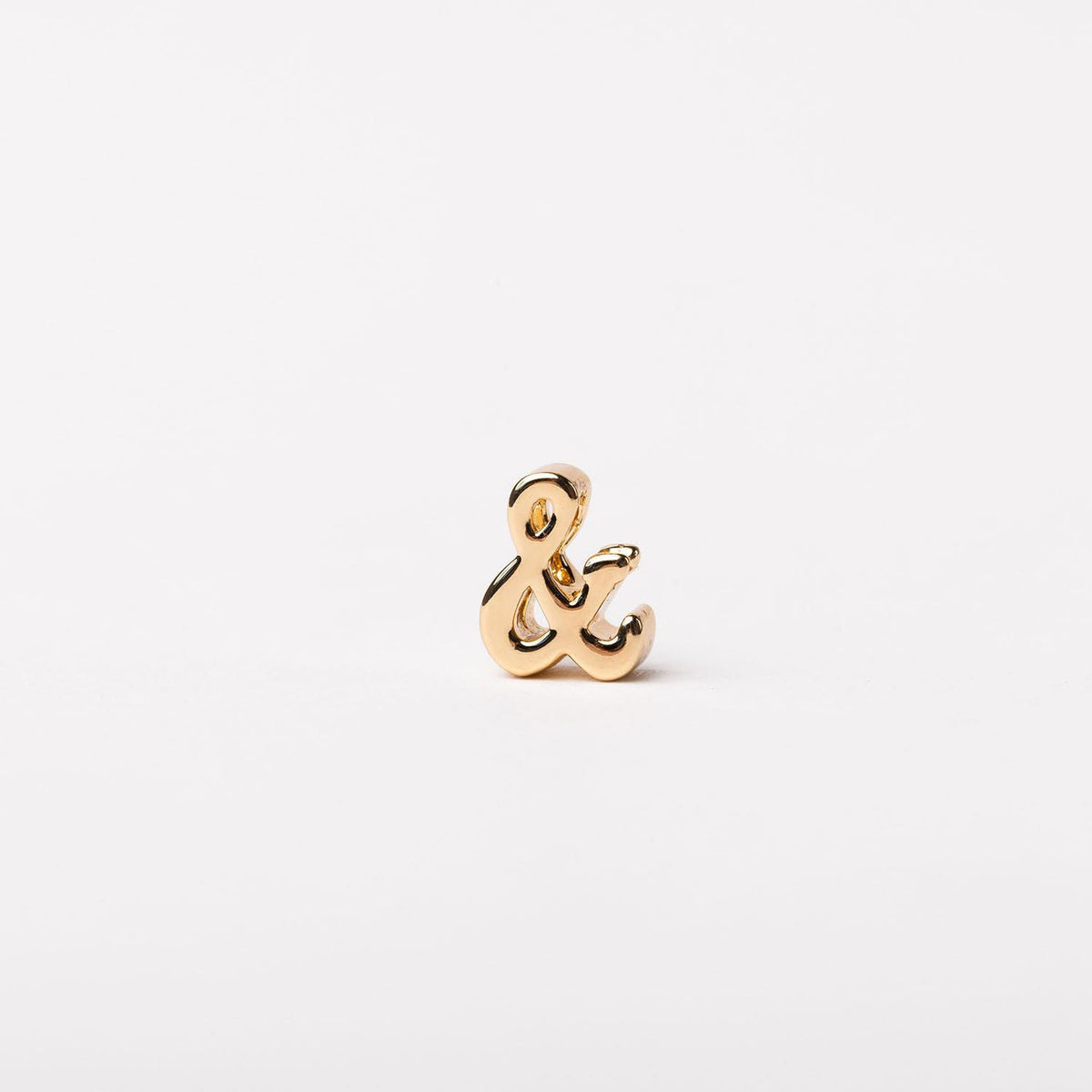 Gold-toned ampersand symbol charm with a polished finish on a plain white background.