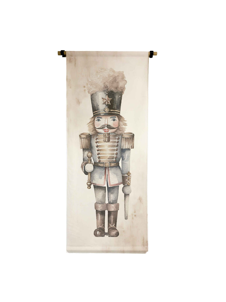 Vertical canvas scroll featuring a watercolor nutcracker in a grey uniform with gold accents.