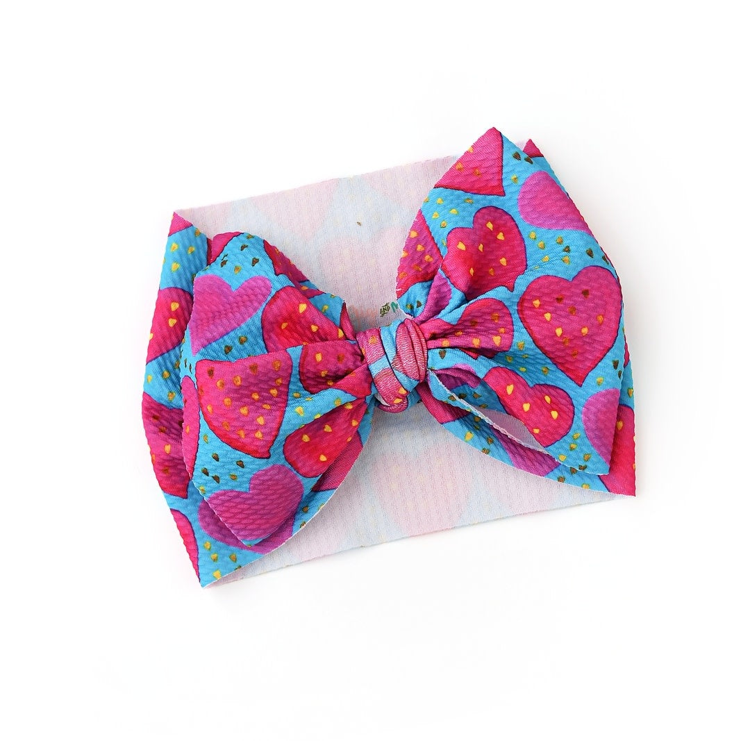 Alaina Hearts headwrap in bullet fabric with a pre-tied bow accent.