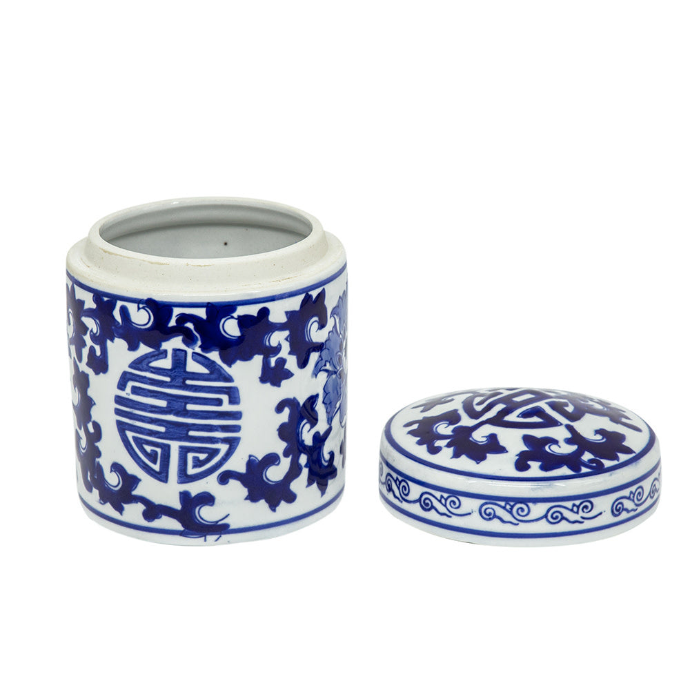 Blue-and-white porcelain tea caddy with Asian-inspired artwork on a square silhouette.