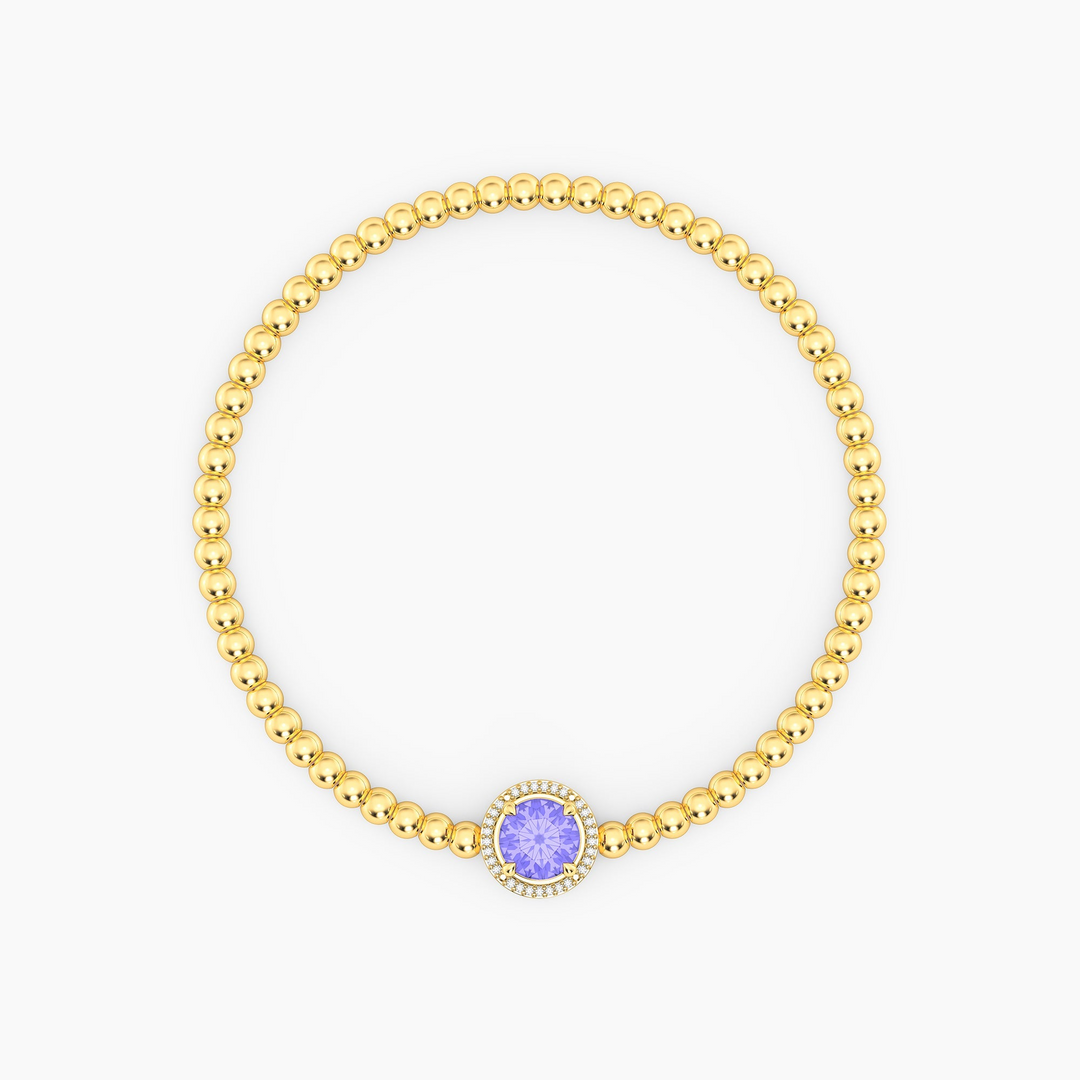 Gold plated beaded bracelet with a round-cut purple tanzanite center stone and diamond halo.