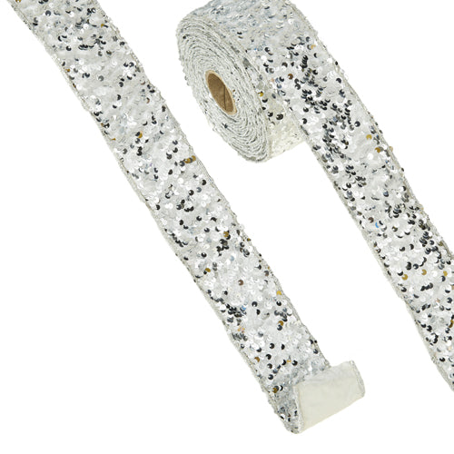 Silver sequined wired ribbon roll measuring 2.5 inches wide by 10 yards long.