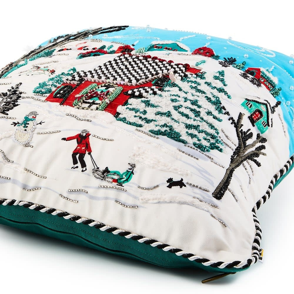 Square cotton throw pillow featuring an embroidered wintry village scene with beaded accents in neutral tones.