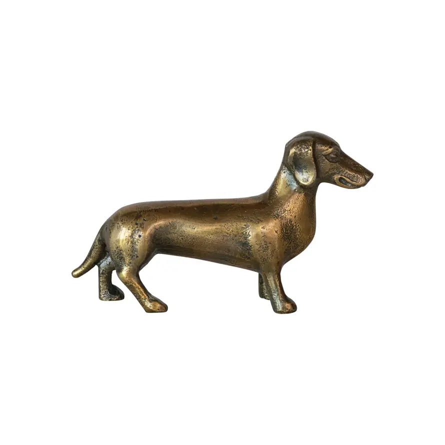 Aluminum accent decor shaped like a dachshund with an antique brass finish.