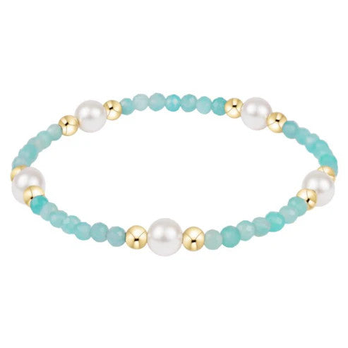Elegant pearl bracelet featuring six-millimeter round beads on a delicate chain.