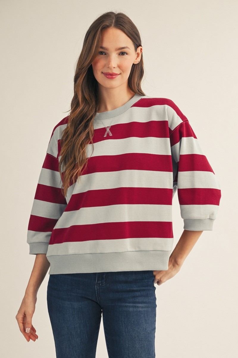 Woman wearing the Roxanne V-Notched Bold Stripe Casual Top in red and grey with 3/4 sleeves.