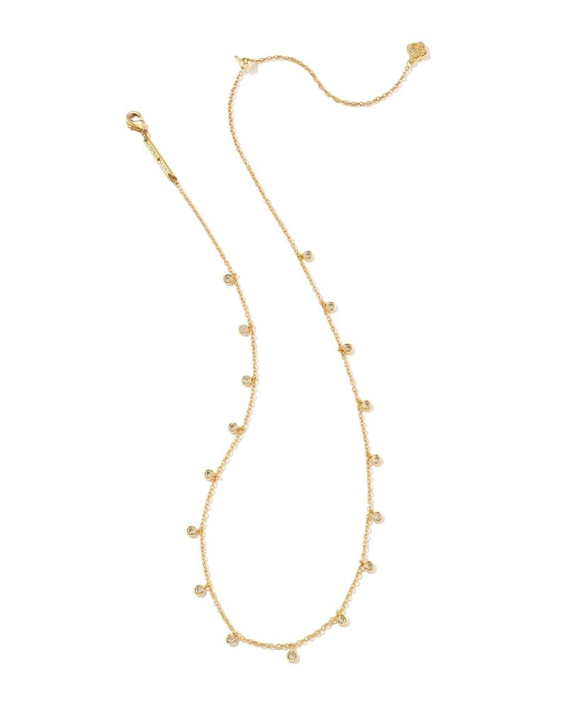 Gold metal chain necklace with delicate crystal charms on a lobster clasp closure.