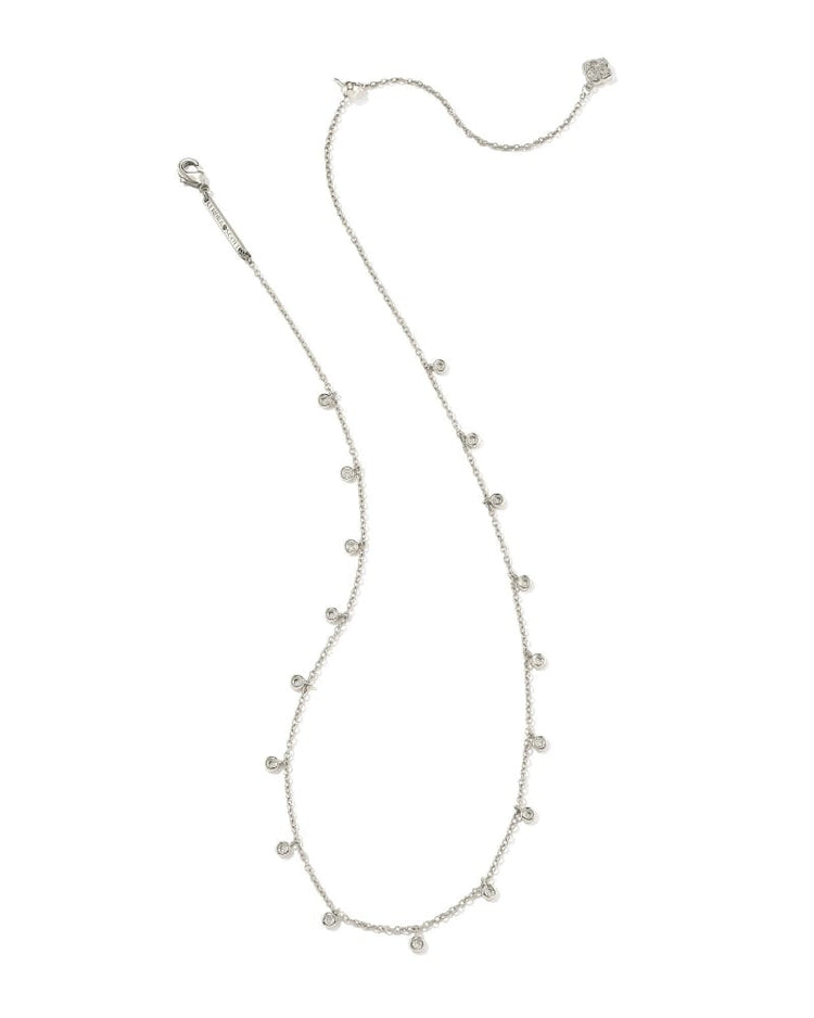 Rhodium metal chain necklace with delicate crystal charms on a lobster clasp closure.