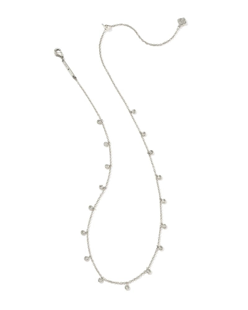 Rhodium metal chain necklace with delicate crystal charms on a lobster clasp closure.