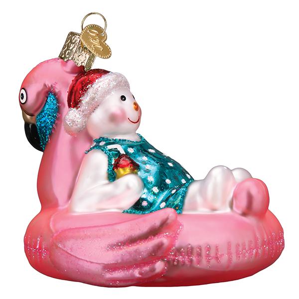 Glass snowman ornament wearing a Santa hat and swimsuit, lounging in a pink flamingo pool float.