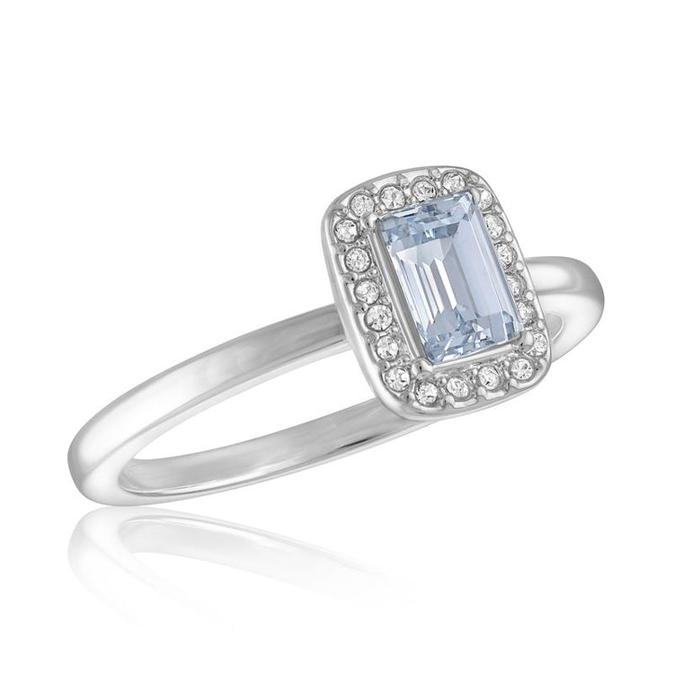 CZ Emerald Cut Stack Ring with a light blue center stone and a halo of small clear stones.