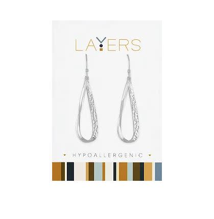 Silver hammered teardrop dangle earrings on a white Layers brand display card.