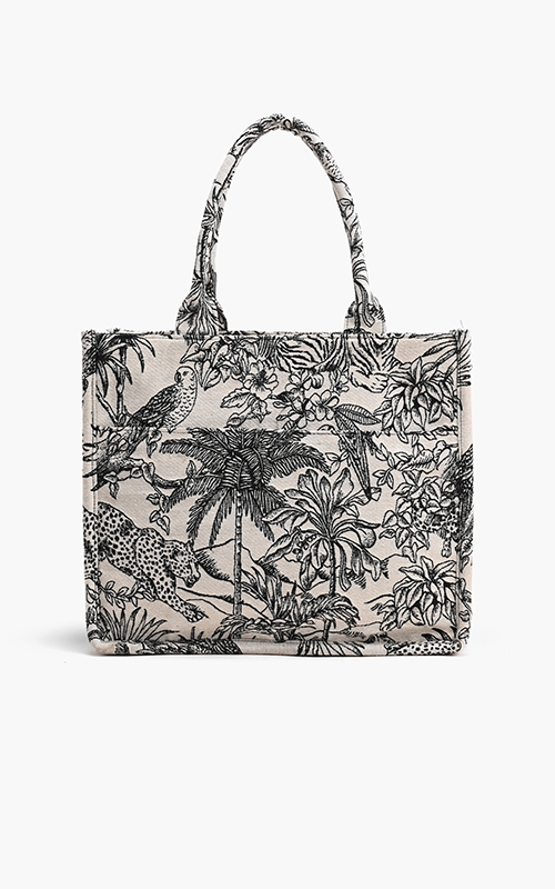 Forbidden Tote in black and white jungle print jacquard with leopard and palm tree motifs.