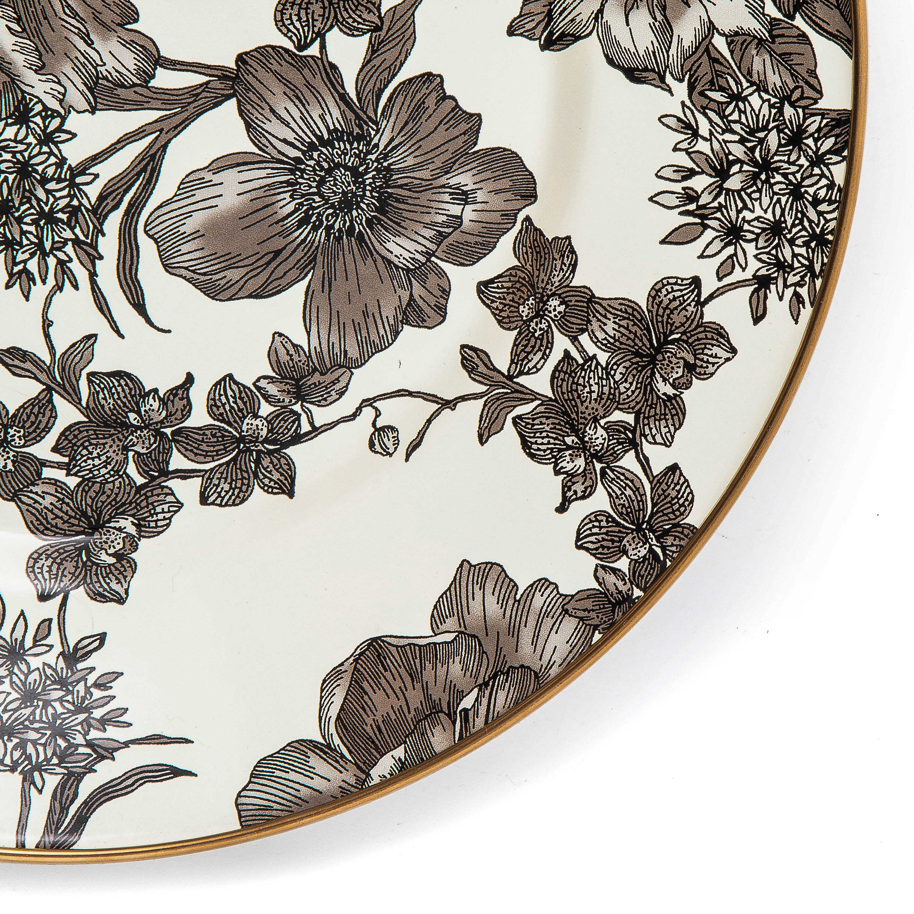 Close-up of a Sterling English Garden Enamel Dinner Plate with black and white floral patterns.