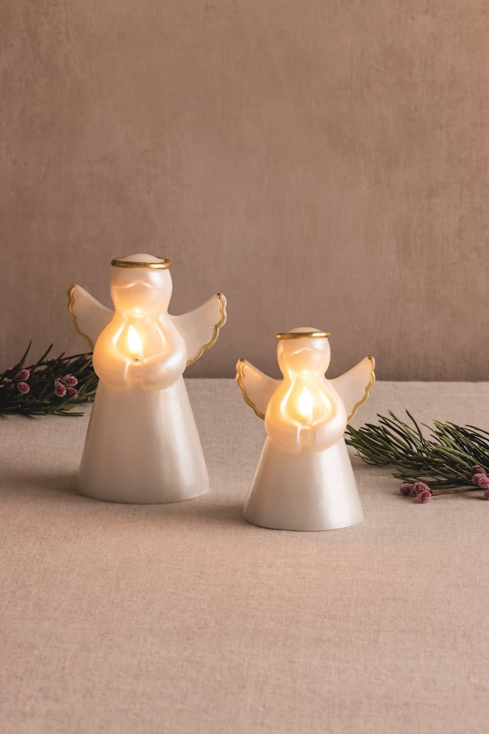 Hand-painted white wax angel figurine with a faux flame effect on its head.