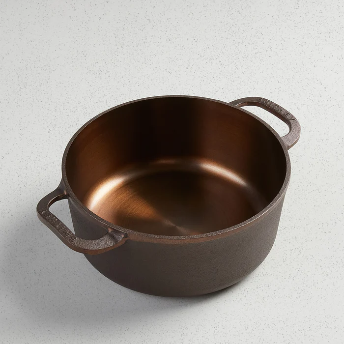 3.5 Qt Dutch Oven with a polished copper-colored interior and dark cast iron exterior.