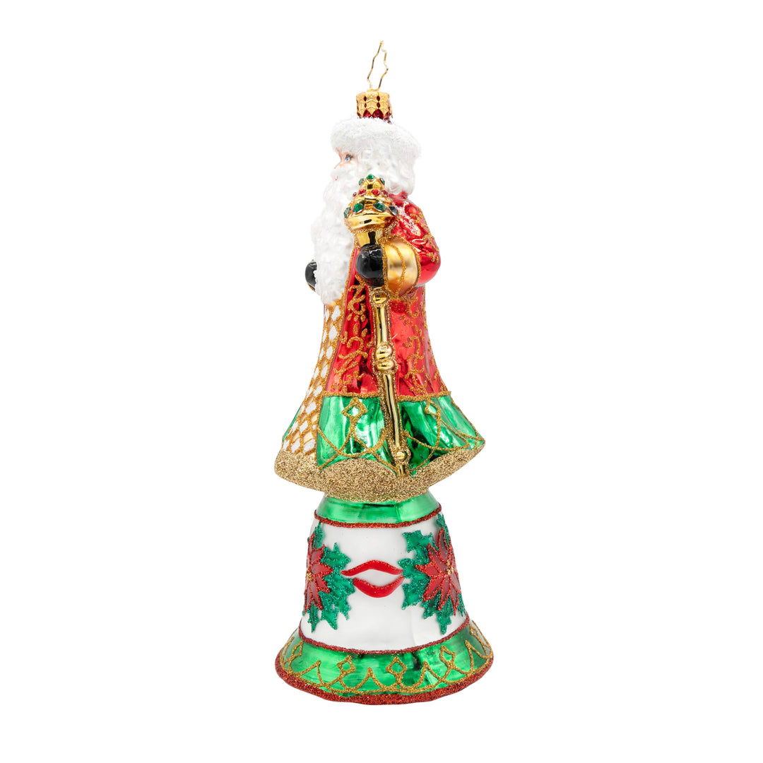 Regal Santa Claus ornament in a red and green coat standing on a white bell with poinsettia motifs.