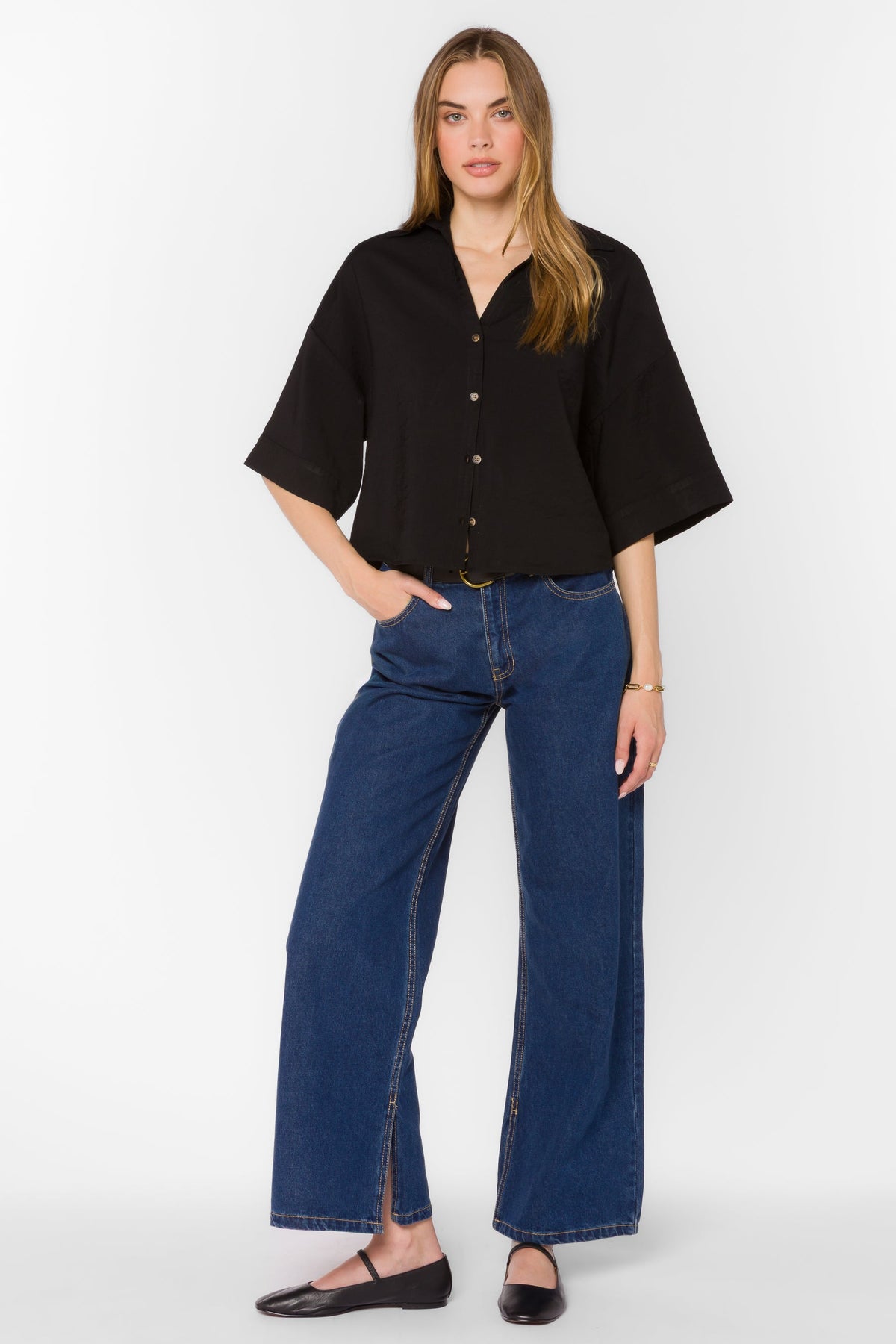 Minx Shirt in light blue viscose blend with collar, Y-neckline, front buttons, elbow sleeves, and high-low hem.