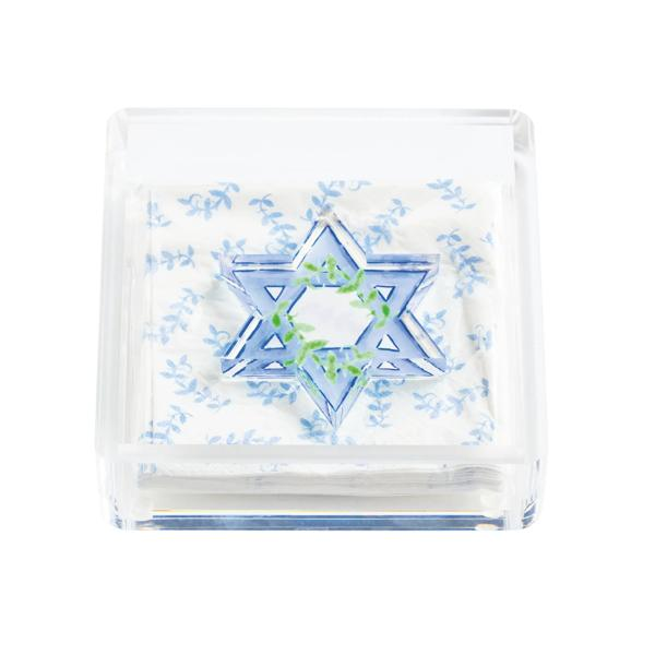 Clear acrylic Hanukkah napkin holder with a blue Star of David weight and floral napkins.