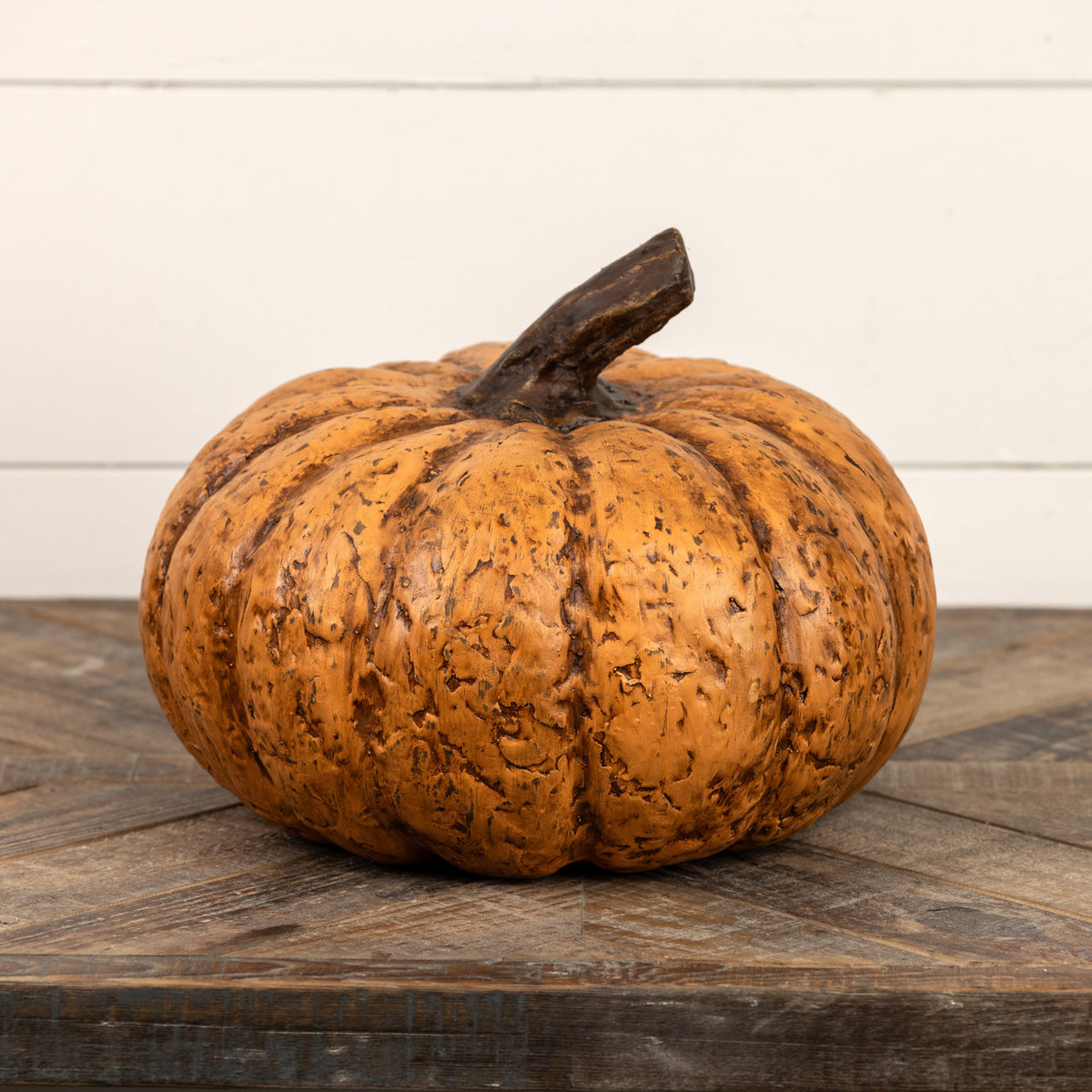 9-inch short terracotta pumpkin with a textured orange finish and dark brown stem.