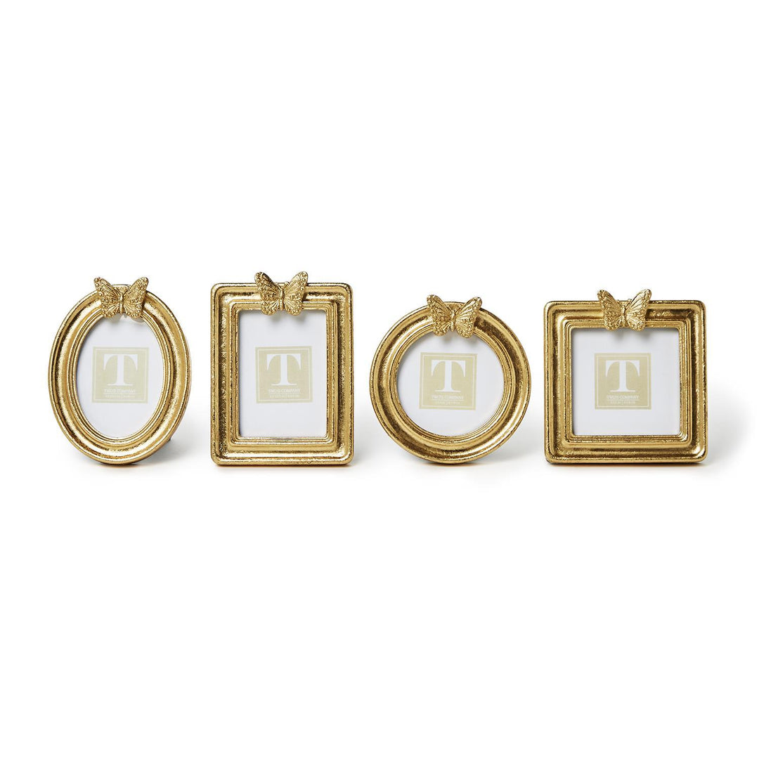 Four gold leaf finish photo frames in oval, rectangle, round, and square shapes with butterfly tops.