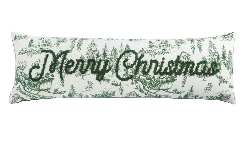 Long white pillow with green toile winter scenes and embroidered "Merry Christmas" in green script.