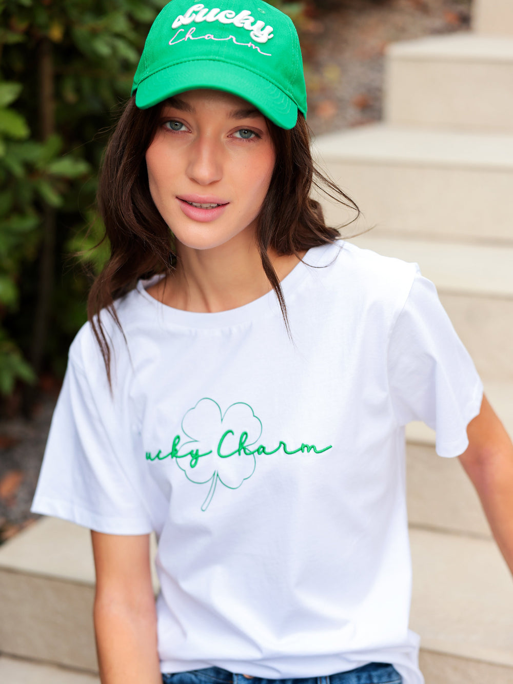 Soft cotton Hannah Lucky Charm T-shirt with embroidered four-leaf clover and playful script on a light background.