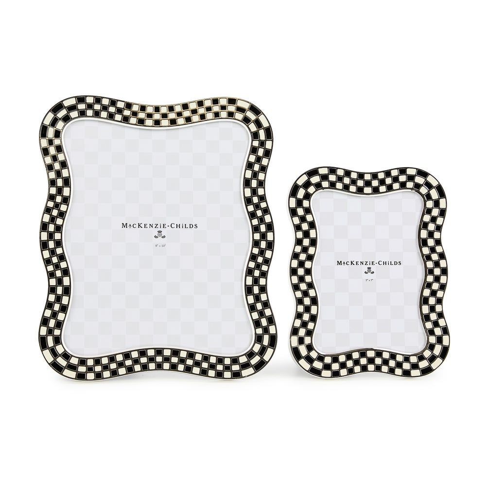 Two wavy silver-plated picture frames with black and white checkered enamel borders.
