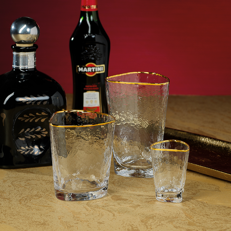 Clear triangular double old fashioned glass with textured surface and gold rim